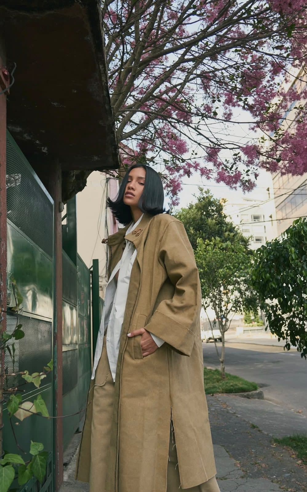 FRAME coat worn open over a white shirt, under a blossoming tree