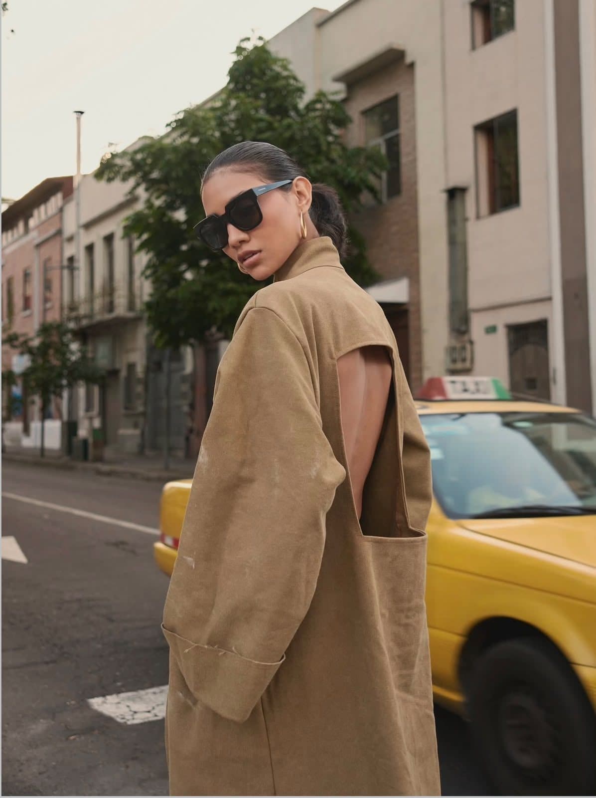 FRAME coat on a city street, a yellow taxi passing behind